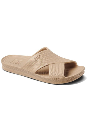 The REEF Water X Slide sandal features a waterproof EVA crisscross strap in beige, a sugarcane EVA footbed with a subtle pattern, and a slightly raised sole with textured edges for better grip.
