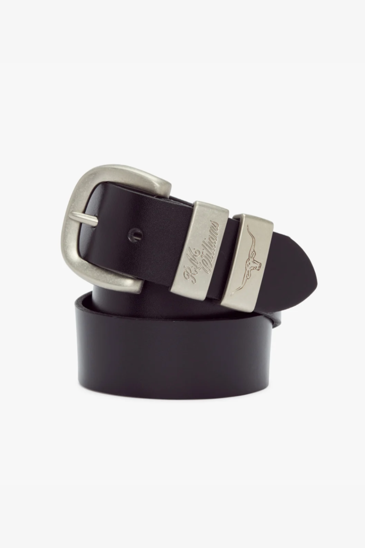 The RM Williams 1 1/2 3 Piece Solid Hide Belt is crafted from solid hide leather and features a brushed nickel buckle with an engraved signature. A longhorn emblem is engraved on a metal loop near the buckle, and when coiled neatly, the belt showcases its sleek, polished black finish.