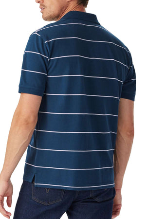 A man shown from the back wears the RM Williams Albany Stripe Polo in navy blue with thin white horizontal stripes, paired with dark blue jeans.