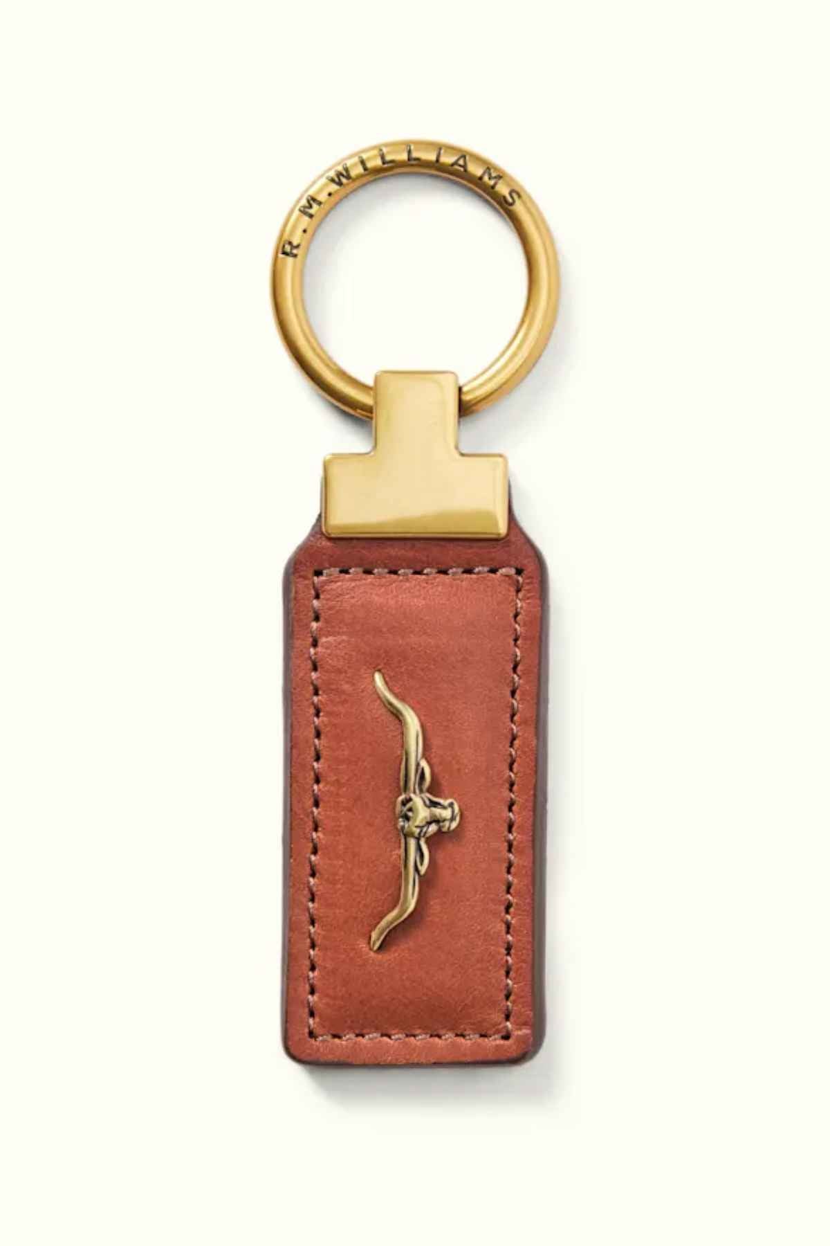 The RM Williams Angaston Key Fob is crafted from brown full-grain leather with antique brass hardware accents and features an embossed longhorn design. It has a keyring made in Australia, engraved with "R.M.WILLIAMS.