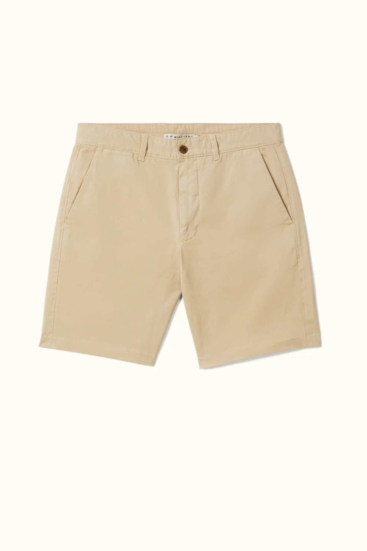 The RM Williams Berwick Chino Short, crafted from organic cotton in khaki beige, features side pockets, a front button, and belt loops. These modern tailored shorts are designed with comfort stretch to ensure a perfect fit and are set against a plain white background.