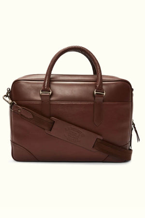 The RM Williams Briefcase is a chic accessory for men, crafted from full grain leather. It includes two handles, a detachable shoulder strap, and features a front zipper pocket with a polished finish.