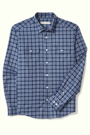The RM Williams Classic Shirt is a long-sleeve, regular fit shirt featuring a blue and white plaid pattern. Made from organic cotton, it includes two chest pockets with buttoned flaps and white buttons down the front and on the cuffs. The lightweight fabric makes it ideal for smart casual wear.