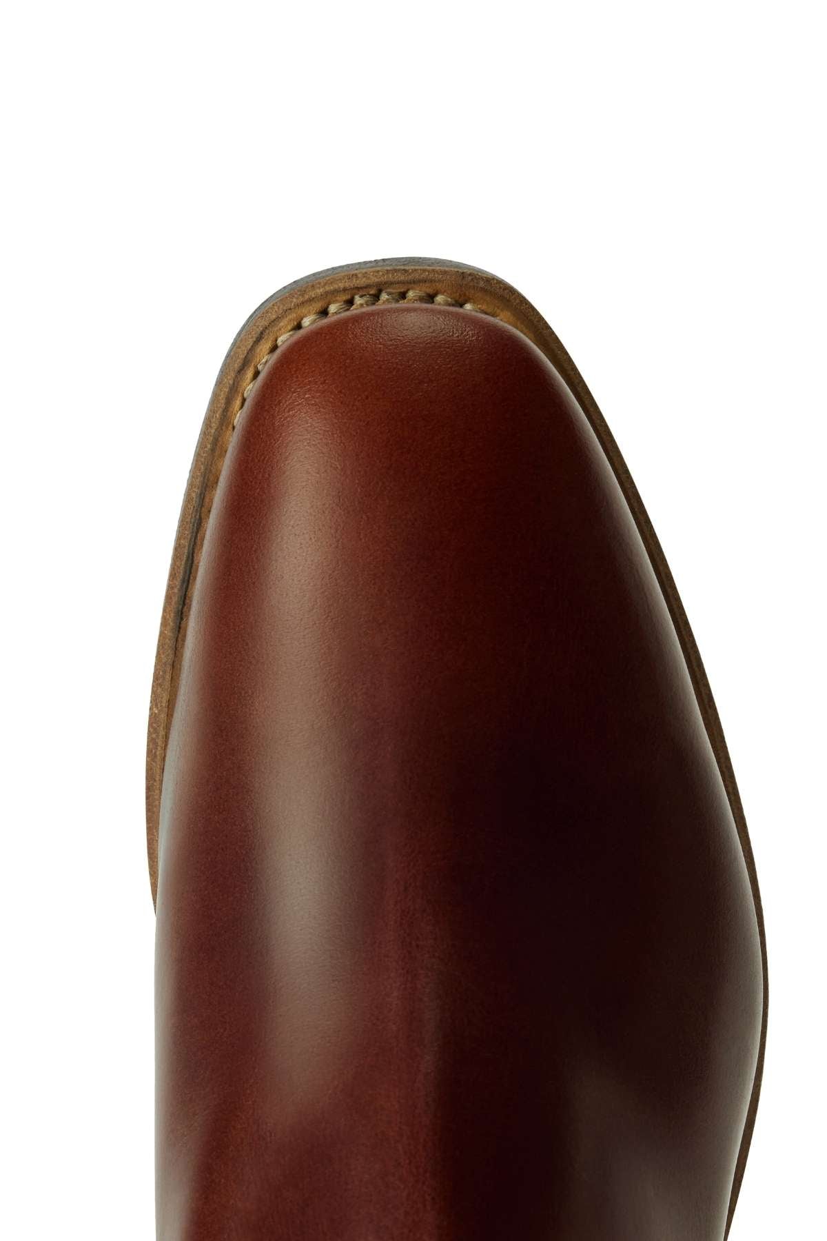 Close-up view of the toe of the RM Williams Comfort Craftsman Boot, featuring brown leather with visible edge stitching and a smooth, polished finish. The boot is photographed against a white background.