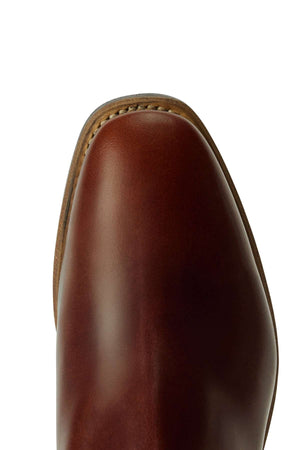Close-up view of the toe of the RM Williams Comfort Craftsman Boot, featuring brown leather with visible edge stitching and a smooth, polished finish. The boot is photographed against a white background.