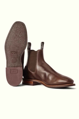 RM Williams Comfort Craftsman Boot in the colour Walnut. Bottom of one boot, sitting next to other boot.