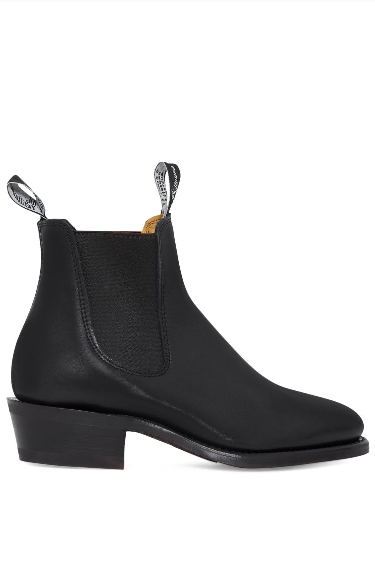 Introducing the RM Williams Comfort Lady Yearling Rubber Sole Boot: These black leather Chelsea boots boast a low block heel, elastic side panels, and dual pull tabs—each adorned with text on the front and back. The dark-colored sole and heel contribute to a sleek appearance in this elegantly elastic-sided design.