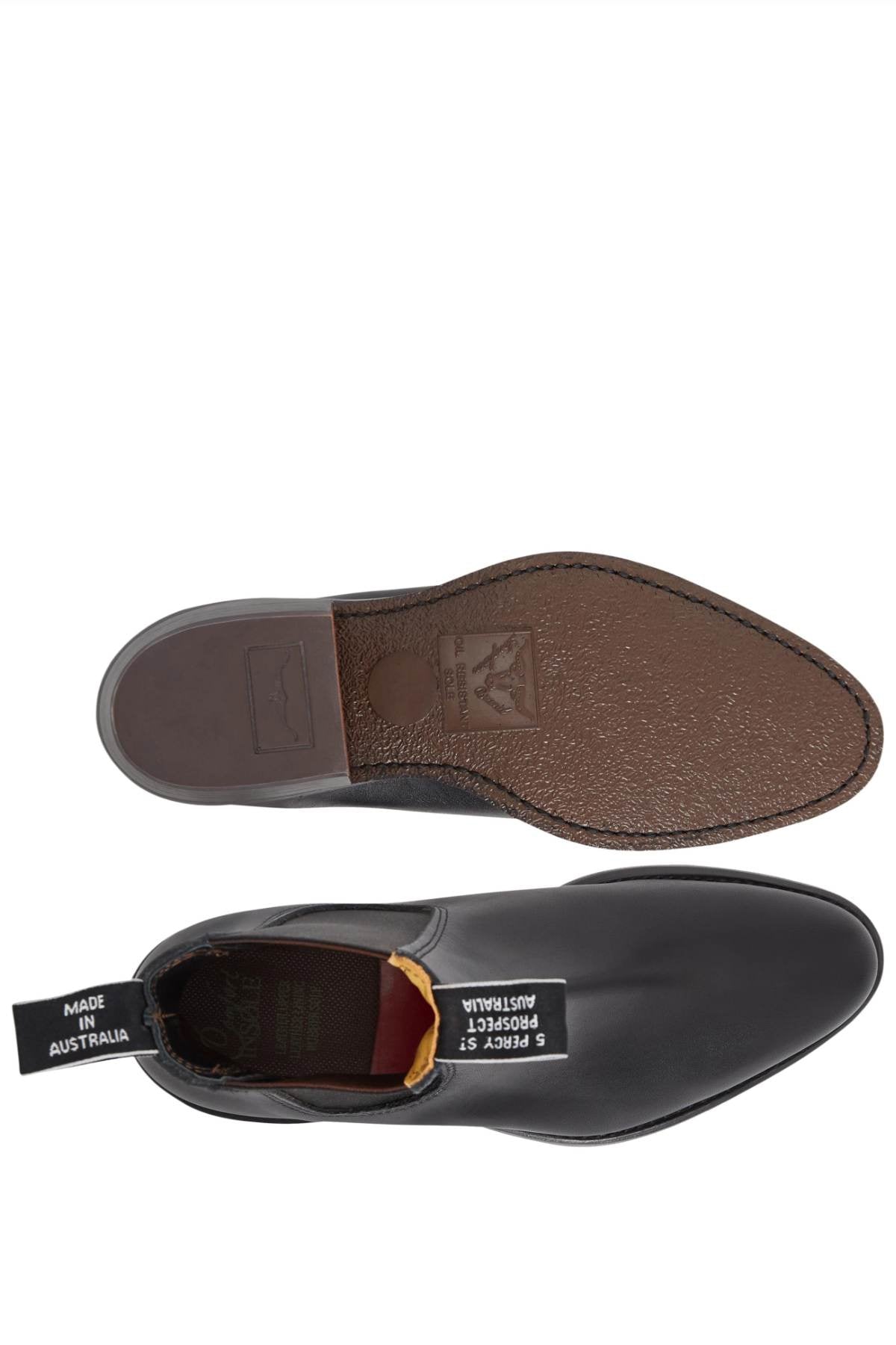 Top and side view of a black RM Williams Comfort Lady Yearling Rubber Sole Boot. The boot features a pull tab labeled "Made in Australia" and showcases a textured pattern with branding visible on the sole. Ideal for style, these boots reflect elegance and comfort without compromising quality.