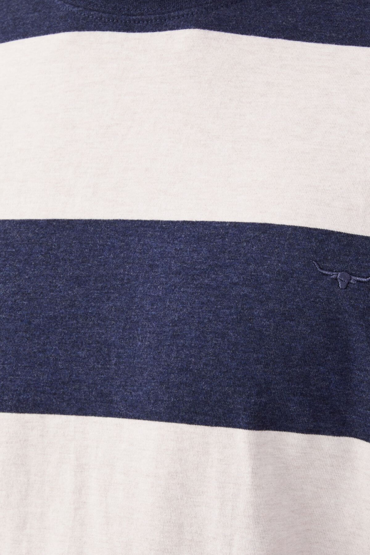 The RM Williams Copley T-Shirt features alternating horizontal stripes in navy and light beige cotton. A small, minimalist longhorn embroidery in navy adorns one of the beige stripes. Its texture appears soft with a slightly heathered finish.