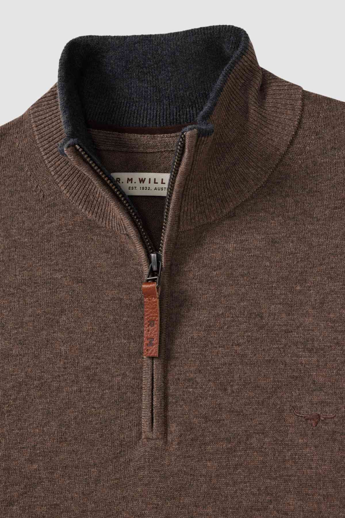The RM Williams Ernest Sweater is a brown fine gauge Merino quarter-zip with a dark inner collar, leather zipper pull tag, and a small embroidered logo on the left chest. The visible inner collar label features printed text.