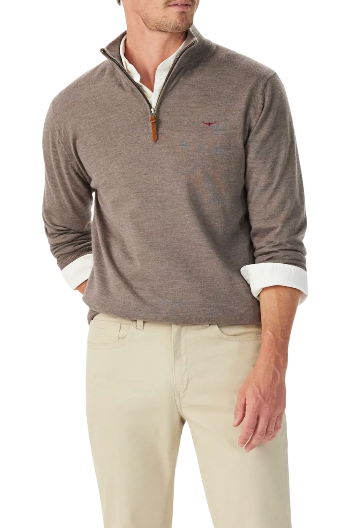 A man, shown from the shoulders down, wears the RM Williams Ernest Merino 1/4 Zip Knit sweater in light brown over a white collared shirt and beige pants, with one hand in his pocket.