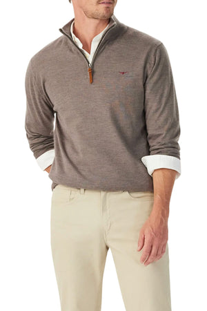 A man, shown from the shoulders down, wears the RM Williams Ernest Merino 1/4 Zip Knit sweater in light brown over a white collared shirt and beige pants, with one hand in his pocket.