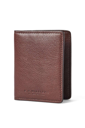 The RM Williams Farrier Fold Cardholder, made of textured brown leather, stands upright on a white background with "R.M. Williams" embossed in small letters on the lower front.