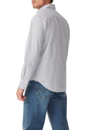 Man wearing the RM Williams Ingham Poplin Stripe Shirt in light blue and white stripes with blue jeans, shown from the back and slightly turned to the side against a white background.