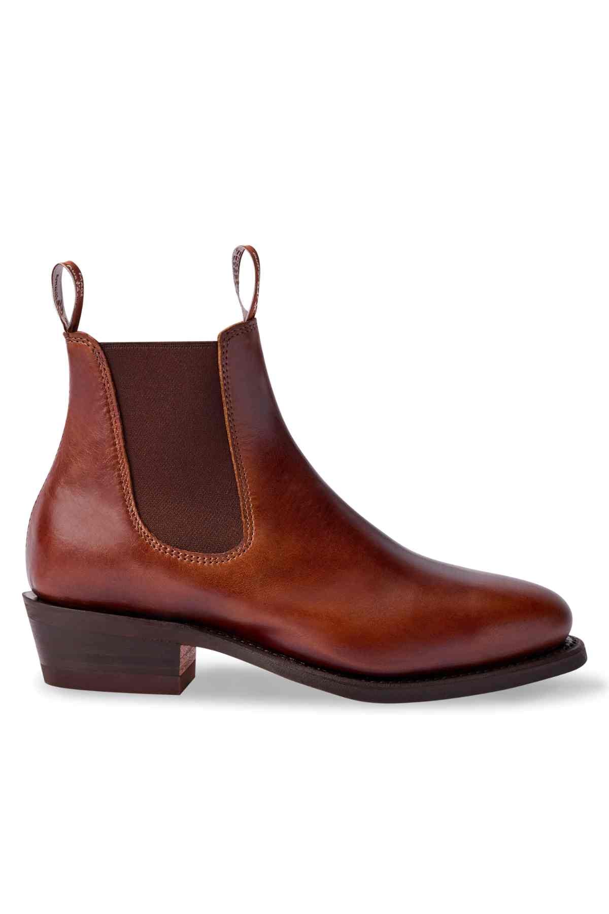 The RM Williams Lady Yearling Rubber Sole Boot is an elegant brown leather Chelsea, made from Spanish pull-up leather. It features elastic side panels, a low heel, pull tabs for easy wear, a slightly pointed toe, and a dark brown sole and heel.