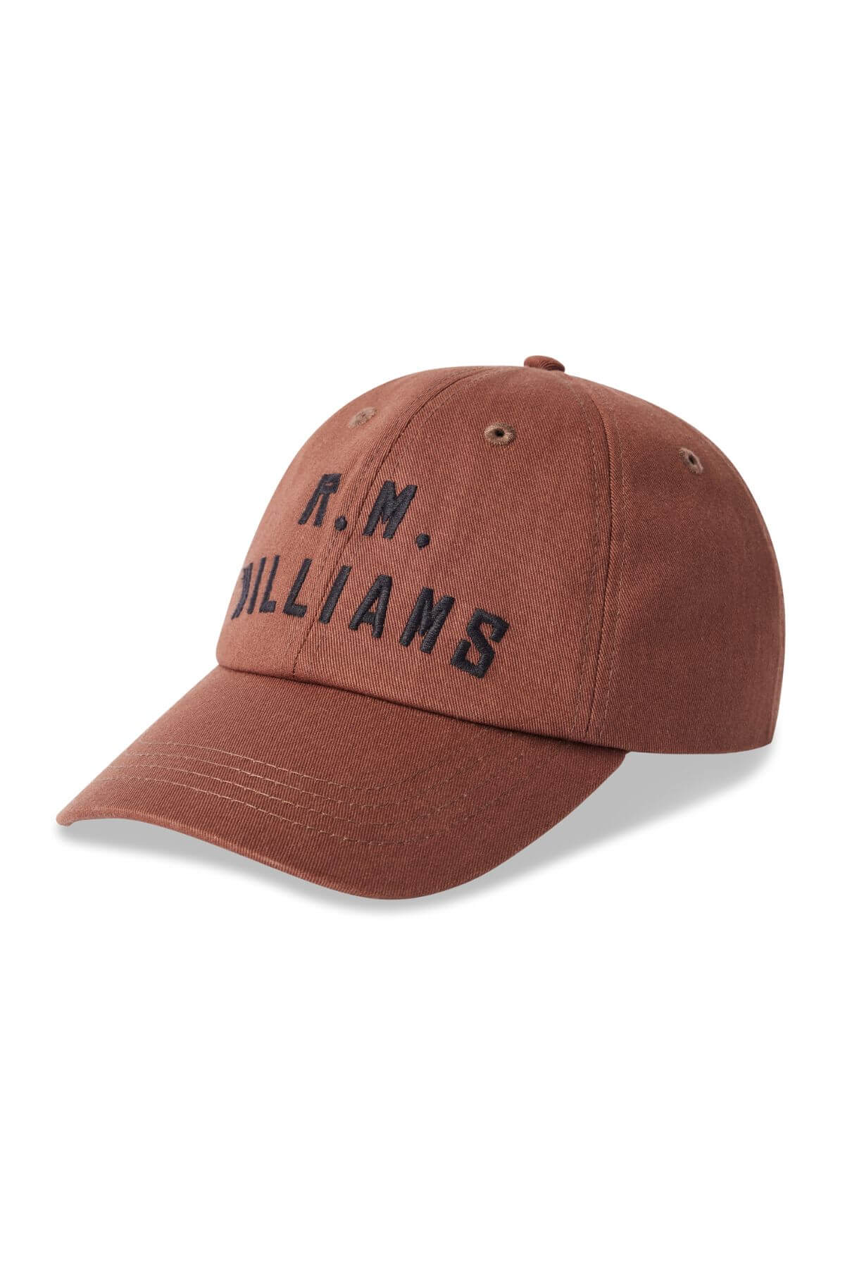 The RM Williams Logo Cap is a brown cotton twill cap with a curved brim and "R.M. WILLIAMS" embroidered in bold black uppercase letters on the front.