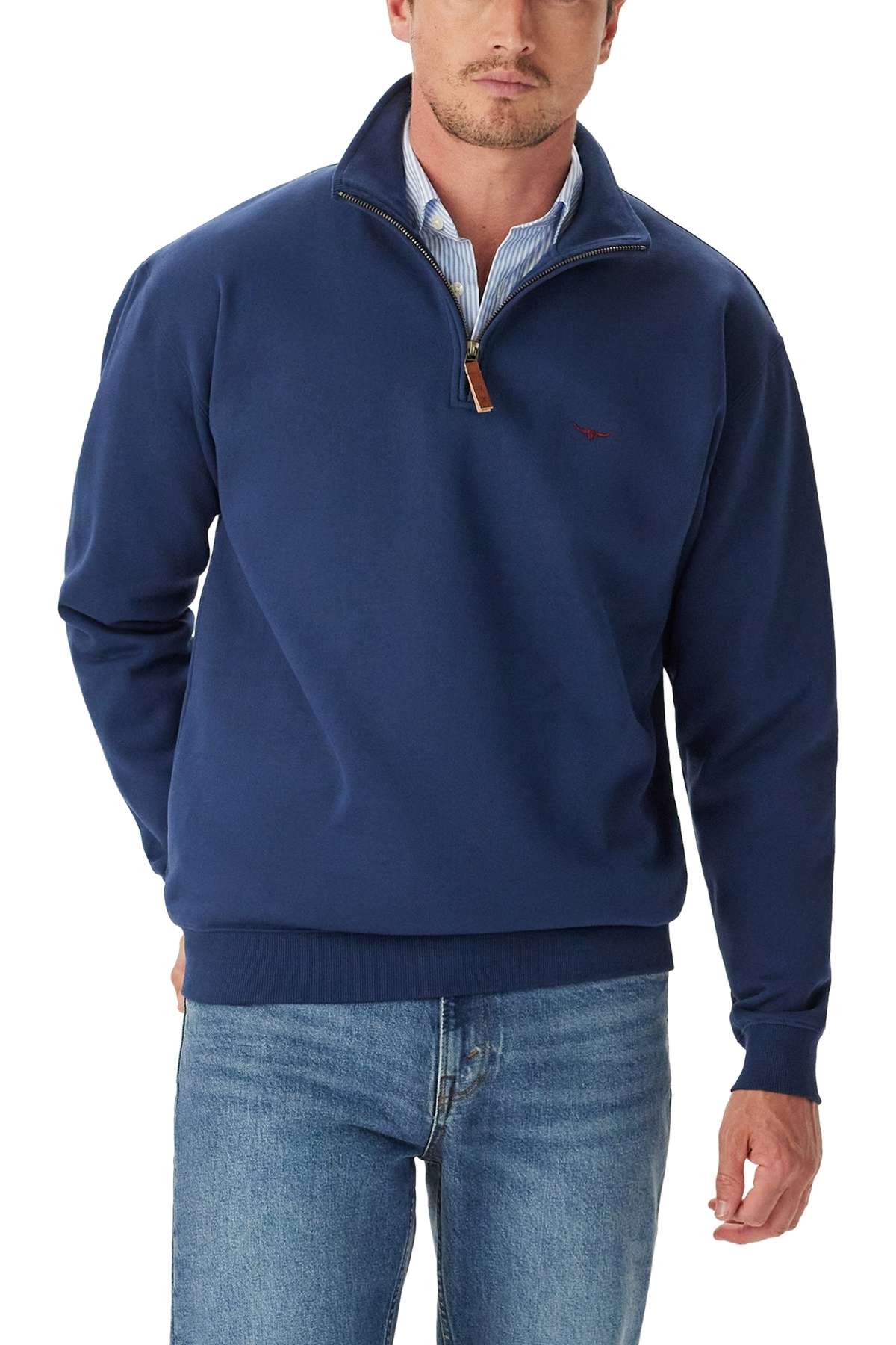 Man wearing the RM Williams Mulyungarie 1/4 Zip Sweatshirt in navy blue over a light blue collared shirt and blue jeans, standing with one hand in his pocket against a white background.