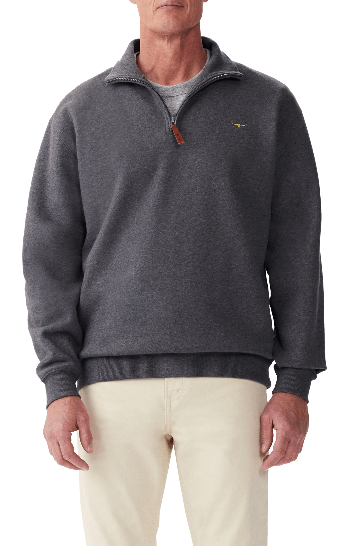 A man stands against a white background wearing the RM Williams Mulyungarie Fleece in charcoal over a gray shirt and light-colored pants.
