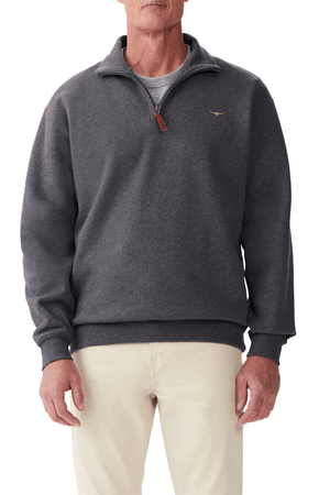 A man stands against a white background wearing the RM Williams Mulyungarie Fleece in charcoal over a gray shirt and light-colored pants.