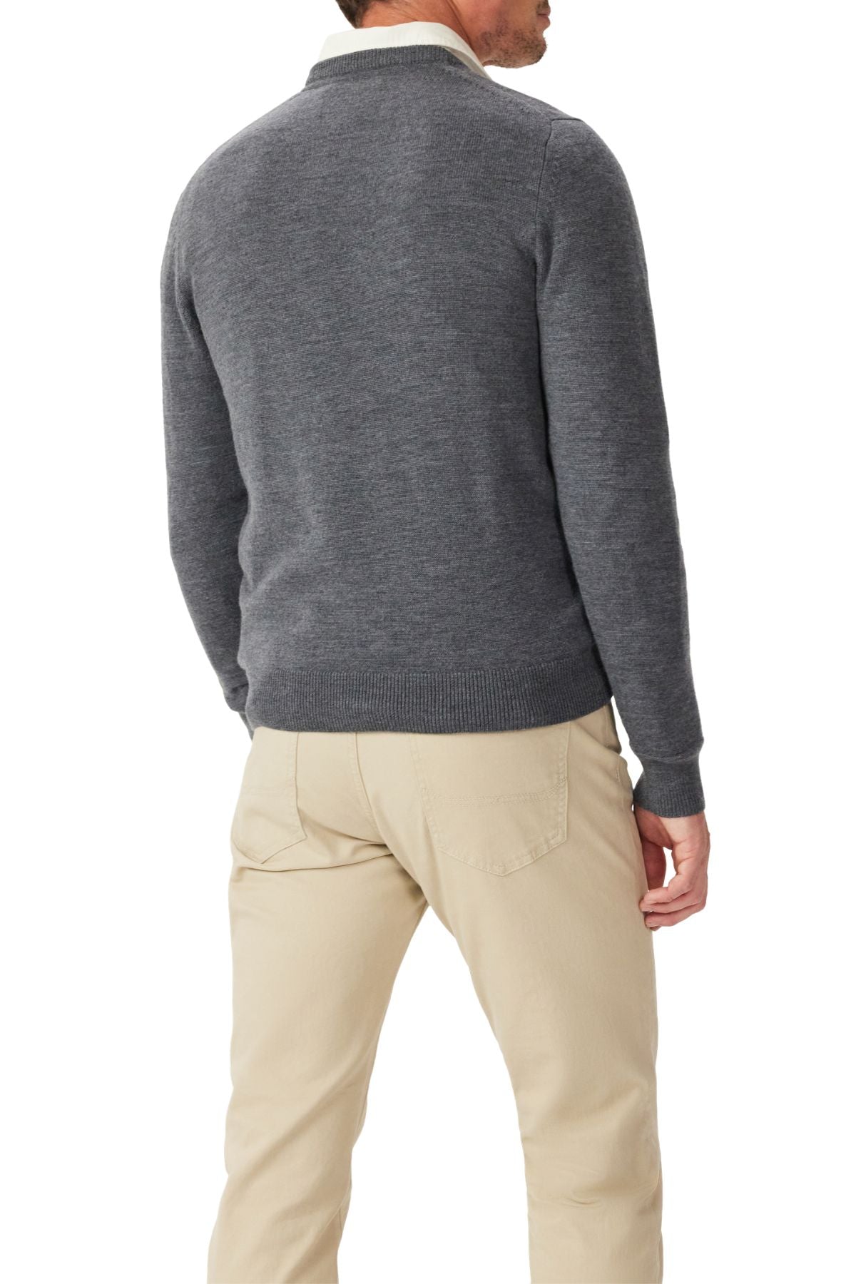 A man facing away from the camera wears a dark gray RM Williams Murphy Merino Crew Knit sweater and light beige pants, standing against a plain white background.