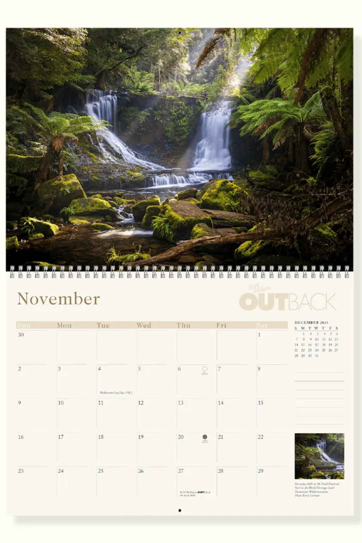 The November page of the RM Williams Outback Calendar 2025 showcases lush forests and cascading waterfalls by Australian photographers, with a day grid below and a thumbnail of the main image in the corner of this stunning wall calendar.