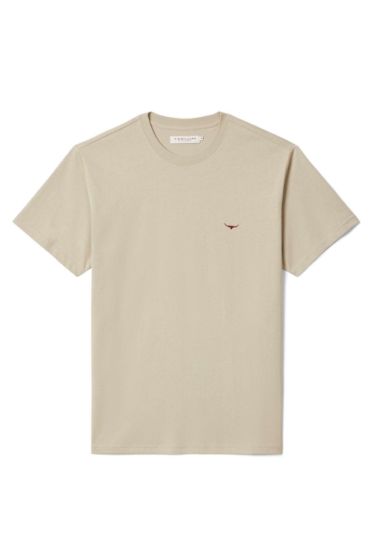 The RM Williams Parson T-Shirt is a beige short-sleeve crew neck featuring a small red longhorn logo on the left chest, shown against a white background.