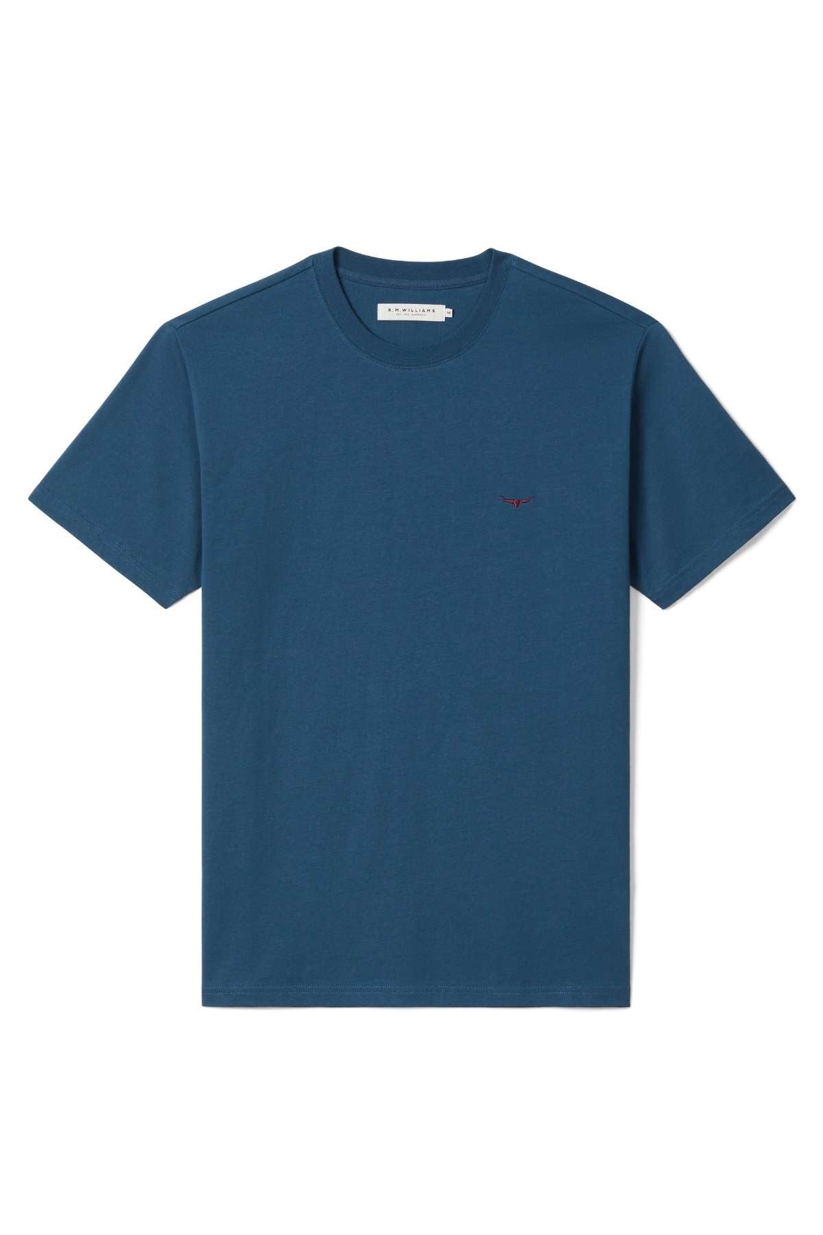 The RM Williams Parson T-Shirt is a plain, short-sleeved, crew neck tee in solid dark blue, featuring a small red embroidered logo on the left chest. The shirt is displayed neatly on a white background.