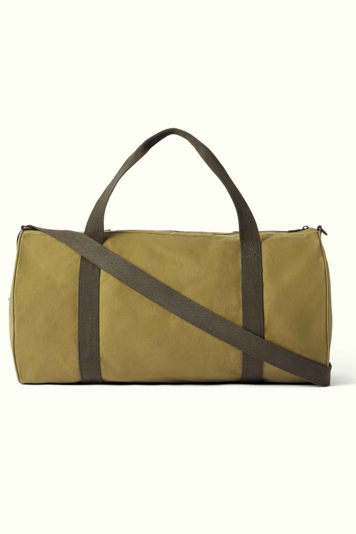 Introducing the RM Williams RM Ditty Bag, a khaki-colored duffel crafted from premium waxed cotton canvas by Halley Stevensons. It features a dark gray strap and handles, and is set against a plain, light background. The perfect travel companion for your next adventure.