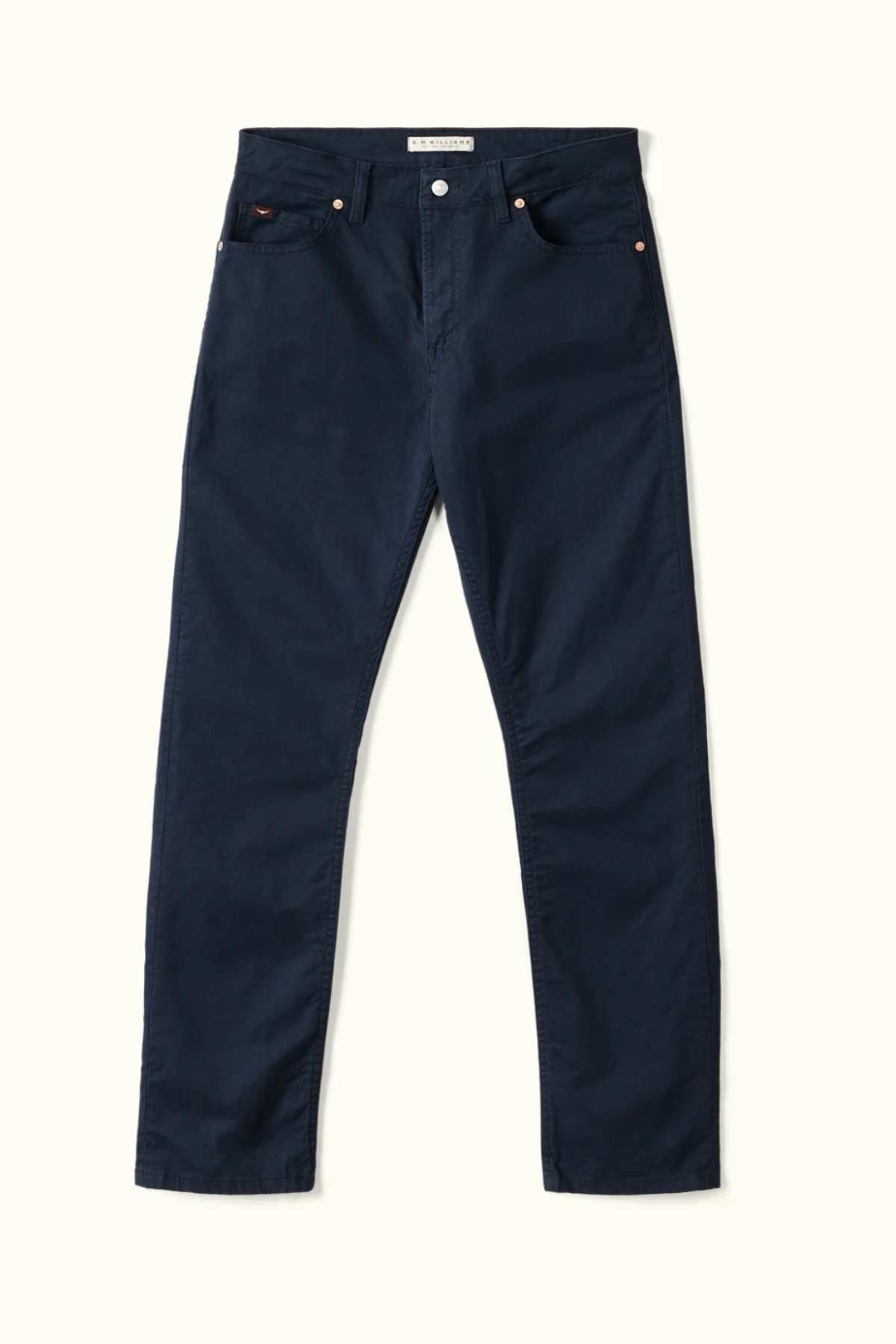 The RM Williams Ramco 5 Pocket Jeans in dark blue, made from stretch cotton twill with a classic five-pocket design, are shown laid flat on a light background.