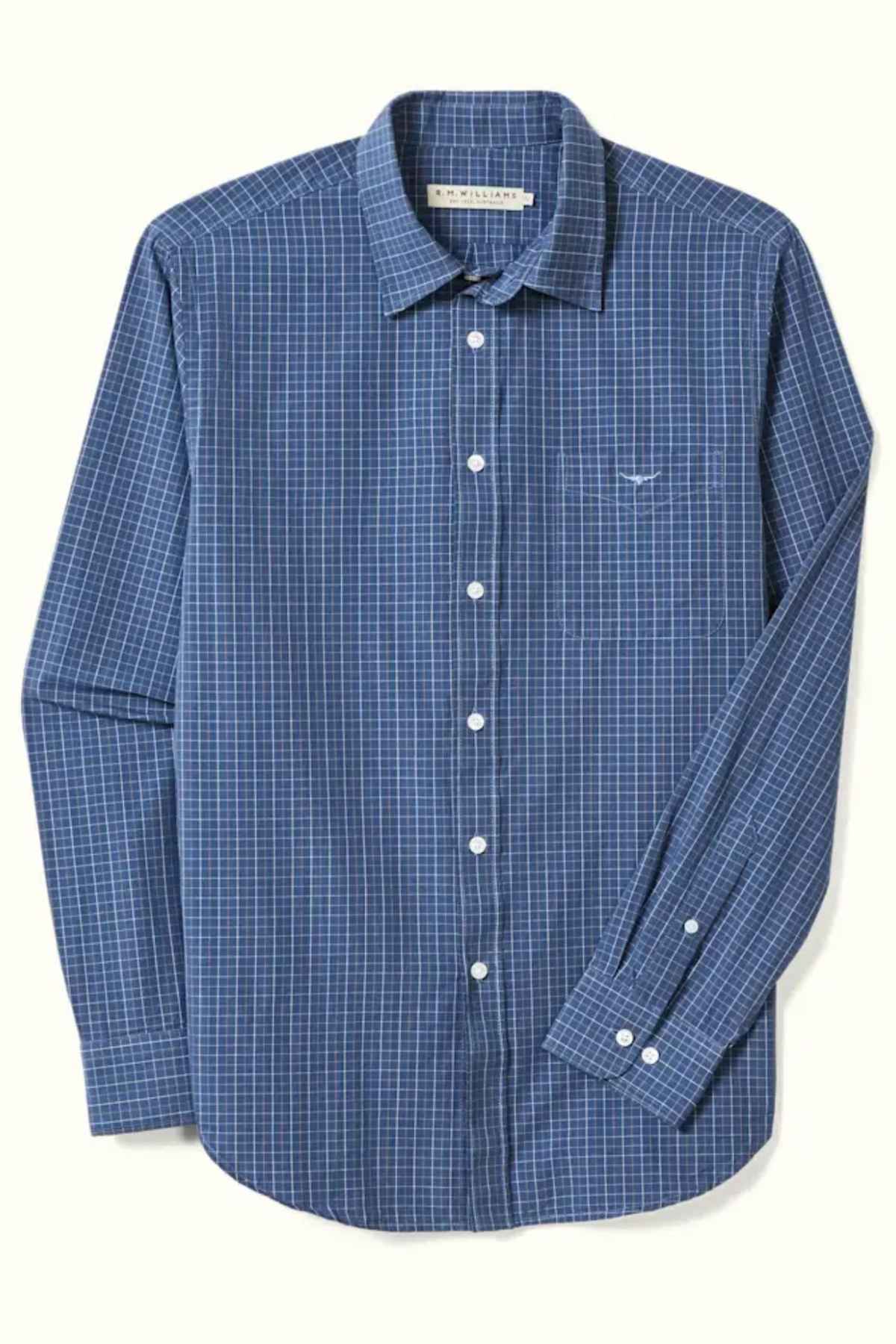 Product Description: The RM Williams Regular Shirt is a long-sleeved, slim fit shirt crafted from Oxford cotton. Designed in a dark blue color with a white and light blue checkered pattern, it features a button down collar, a front chest pocket on the left side, and white buttons down the front and on the cuffs.