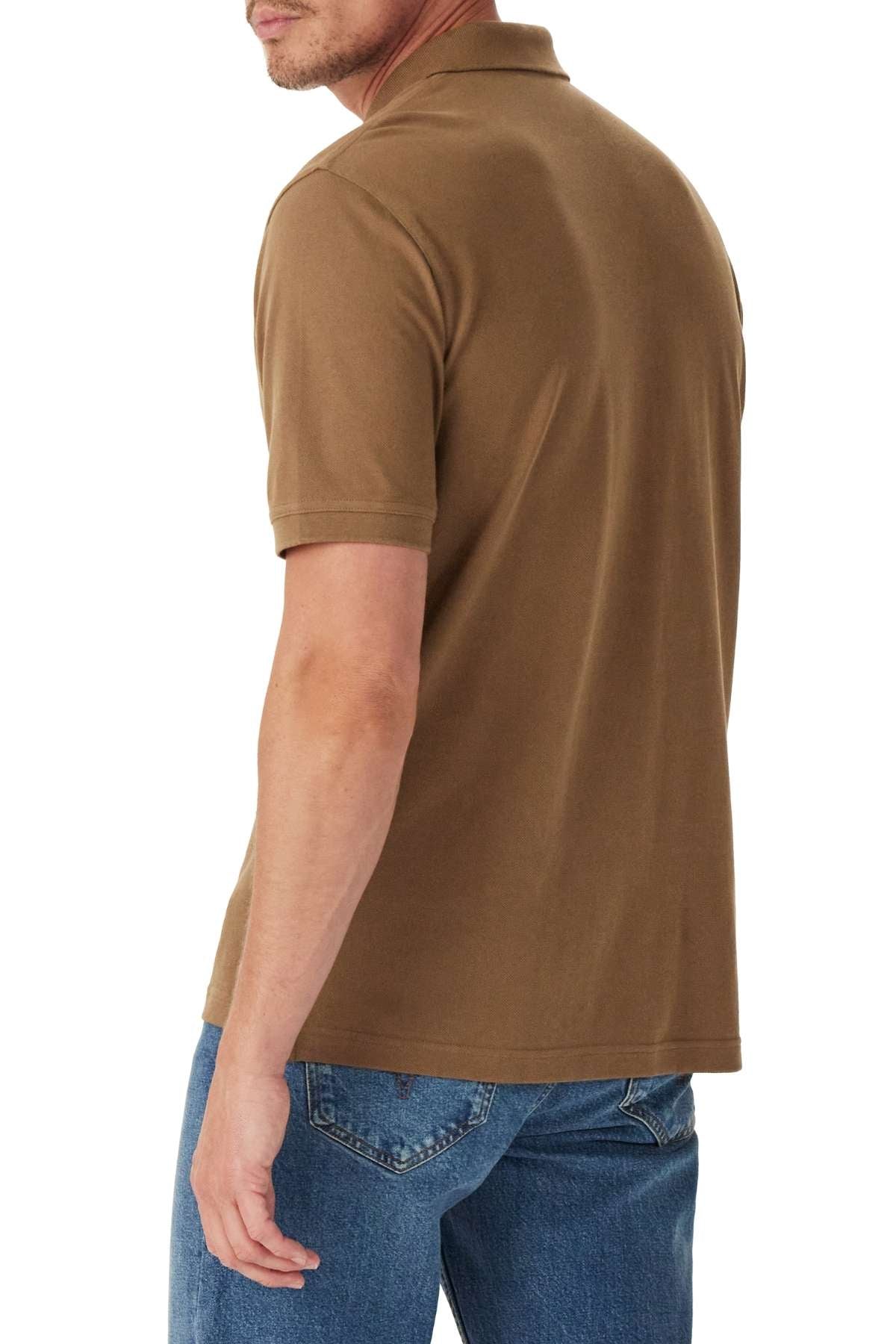 A man is shown from the back, turning slightly to his left against a white background, wearing the RM Williams Rod Polo in brown and blue jeans.