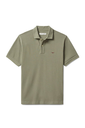 The RM Williams Rod Polo is an olive green classic made from organic cotton pique with short sleeves, a collar, and a small Longhorn embroidery on the left chest, shown against a plain white background.