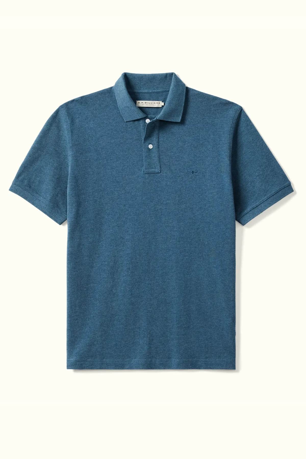 The RM Williams Rod Polo, made from organic cotton, offers a classic fit with short sleeves and a collar. It includes a three-button placket and a small embroidered logo on the chest, all presented against a simple background.