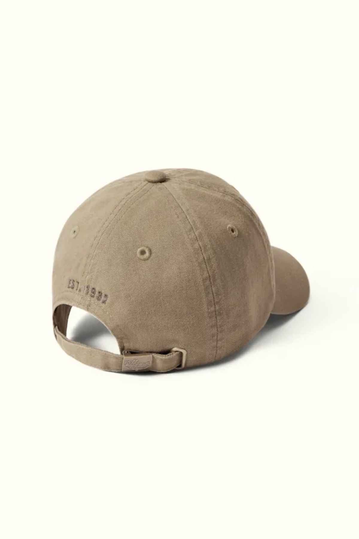 Viewed from the back, the RM Williams Script Longhorn Cap is a brown baseball cap made from washed cotton twill. It features an adjustable strap and subtly embroidered text reading "EST. 1992." Its simple design and neutral color lend it a casual look.