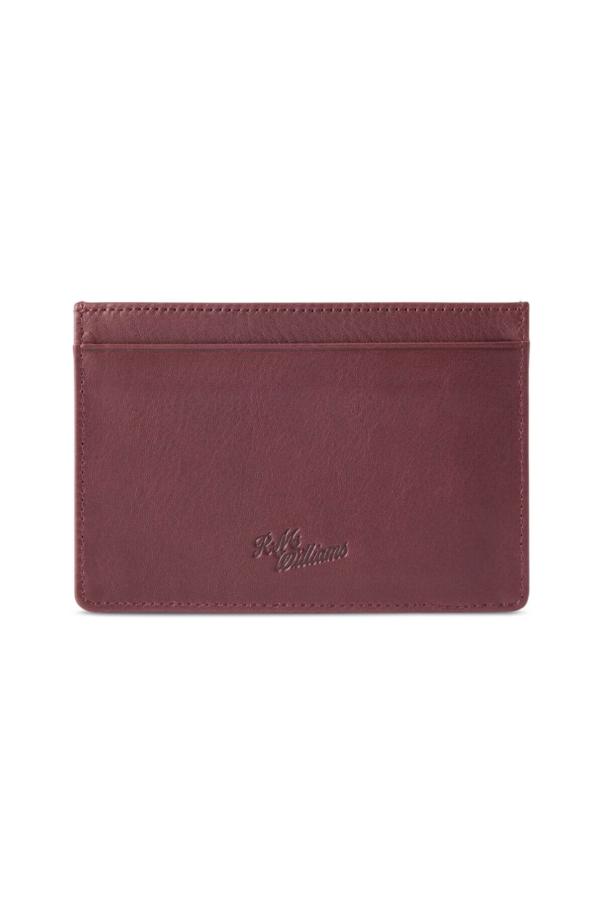 The RM Williams Singleton Vertical Card Holder is a slim, rectangular leather wallet in a rich brown color, featuring minimal stitching and a small embossed logo in the center of one side. Handmade in Australia from natural milled leather, it has one central pocket and several card slots for organization, along with RFID protection.