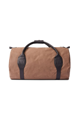 The RM Williams Sorrento Ute Bag is a tan utility canvas duffel with black leather trims and handles, displayed against a white background.