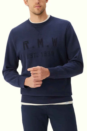 RM Williams Stencil Crewneck Sweatshirt in the colour Midnight. Model wearing jumper
