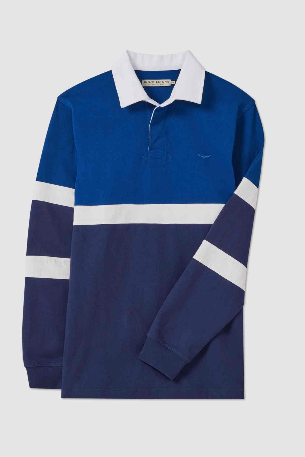 The RM Williams Tweedale Rugby is a long-sleeve shirt that combines navy blue and royal blue colors. It features a white horizontal stripe across the chest and on both sleeves, complemented by a white collar. For added flair, there is also a small longhorn embroidery on the left chest.