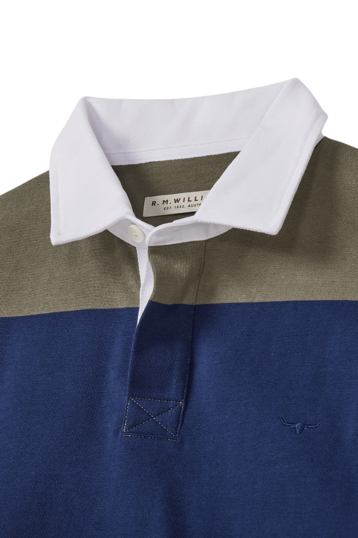 A close-up of the RM Williams Tweedale Rugby shows its heavyweight jersey knit, white collar, olive green upper, and blue lower section with a small longhorn embroidery logo on the blue chest fabric.