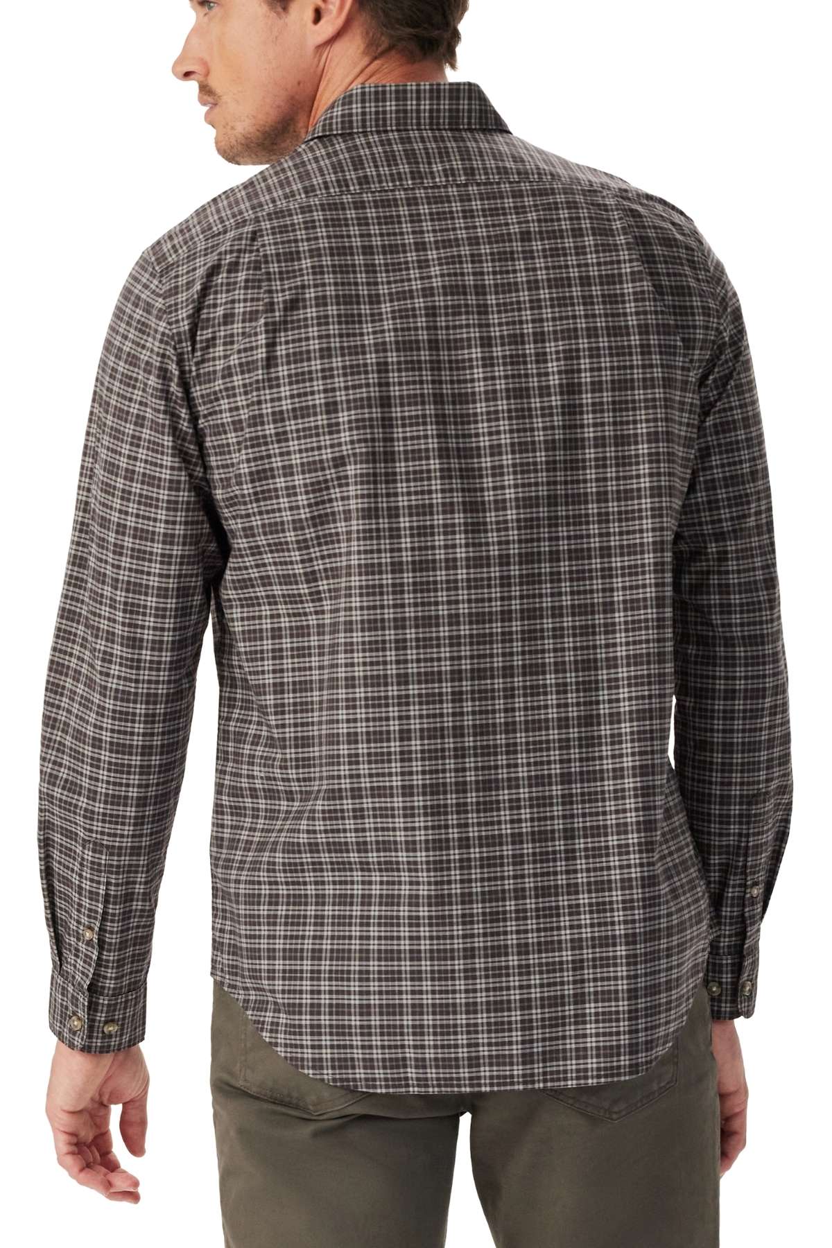 A man is standing with his back to the camera, wearing the RM Williams Warrah Poplin Check Shirt in a brown and gray plaid pattern and olive green pants.