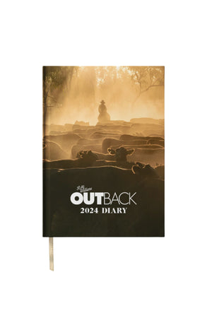 Cover of the RM Williams Outback Diary 2024, a premium hardcover featuring striking photos such as a sepia image of a rider herding cattle through dust and sunlight in the rural Australian outback.