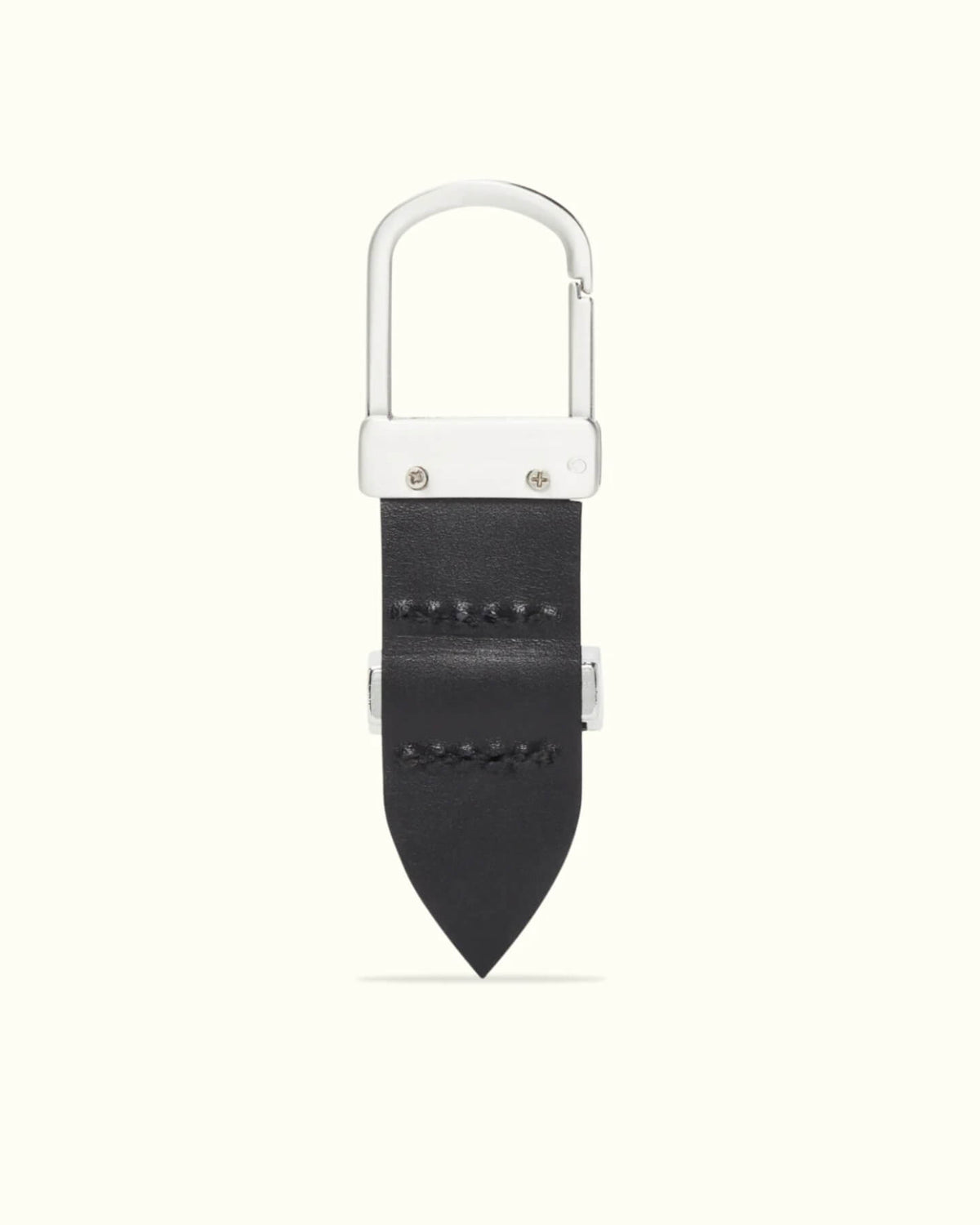 Introducing the RM Williams Drover Key Fob: a sleek keychain featuring a silver carabiner clip on a black double butt leather strap with visible stitching, antique brass hardware, and a pointed end, all against a light gray background for an elegant look.