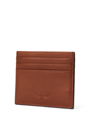The RM Williams Farrier Cardholder is a brown, full grain leather card holder with three slots, simple stitching, and a small embossed longhorn logo on the front center.