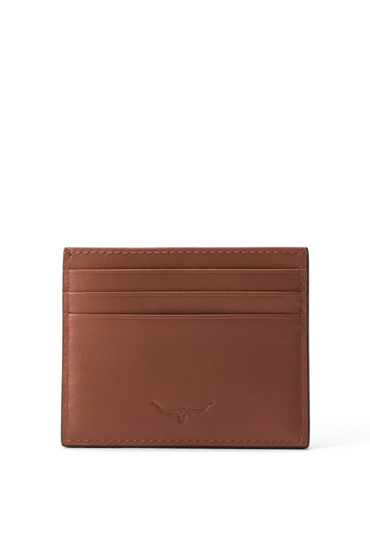 The RM Williams Farrier Cardholder is a brown full grain leather piece with multiple card slots and a subtle embossed longhorn logo on the front, shown against a white background.