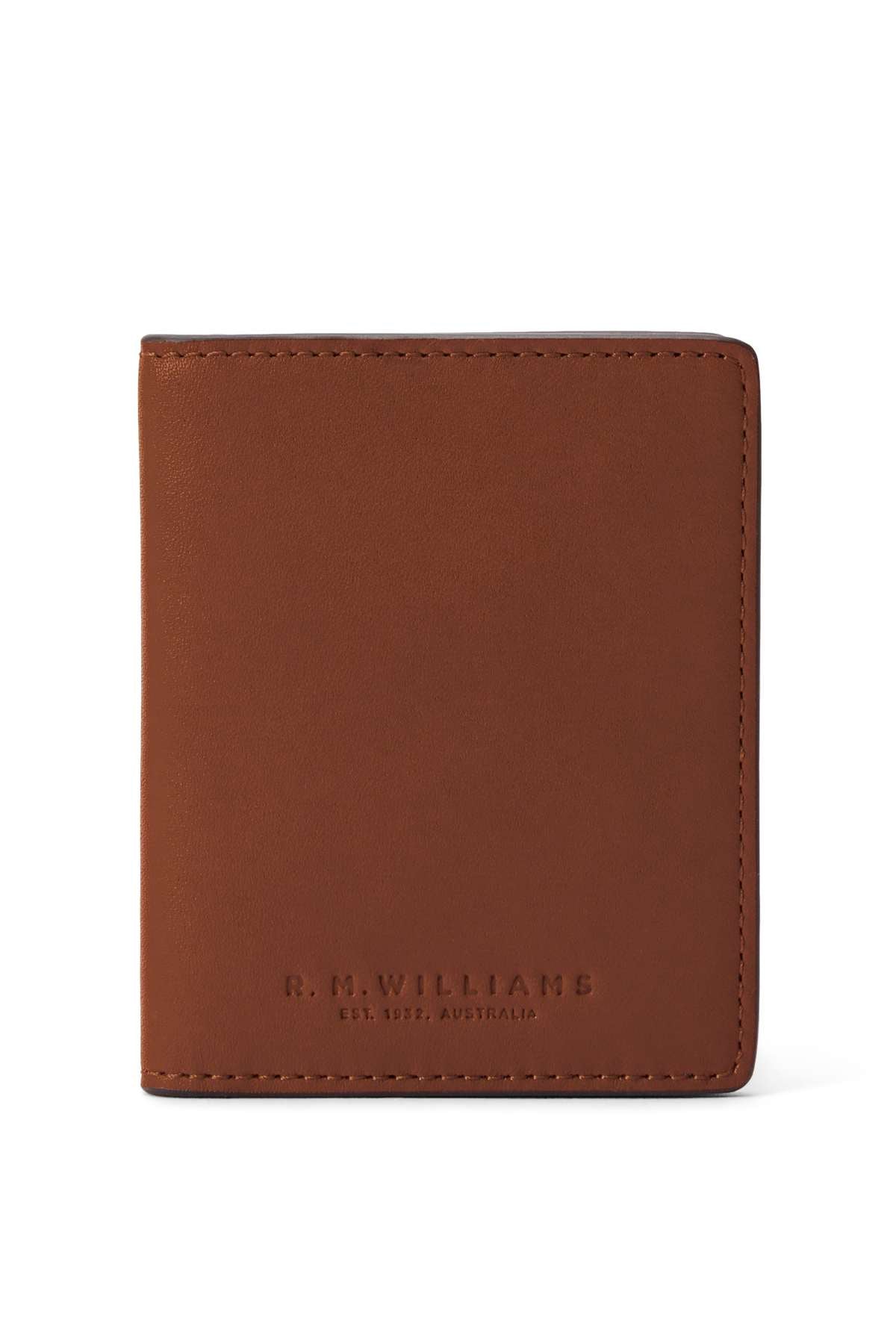 The RM Williams Farrier Fold Cardholder, crafted from full grain leather, stands upright with “R.M.Williams Est. 1932, Australia” embossed near the base. The white background accentuates its classic look and practical interior card slots.