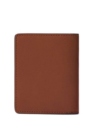 A closed RM Williams Farrier Fold Cardholder made of full grain leather with visible edge stitching, standing upright against a plain white background.