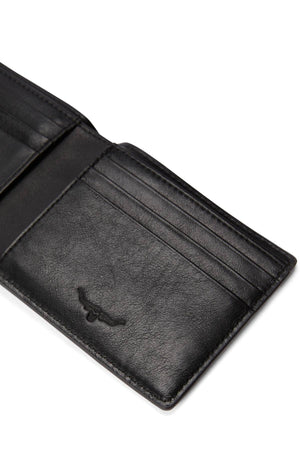 A close-up of the RM Williams Farrier Slim Bi Fold Wallet in black full grain leather, showcasing multiple card slots and a subtle embossed longhorn logo on one side.