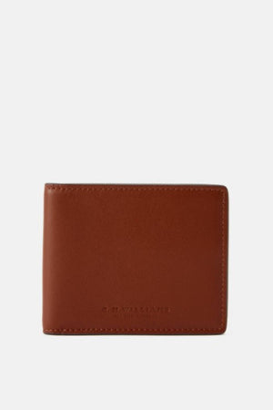 The RM Williams Farrier Slim Bi Fold Wallet is a closed, brown full grain leather wallet with visible edge stitching and a subtle embossed logo at the bottom center, displayed against a plain white background.