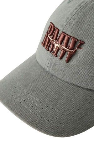 A close-up of the RM Williams Heritage Twill Cap in gray, featuring brown embroidered text and a barbed wire design on the front.