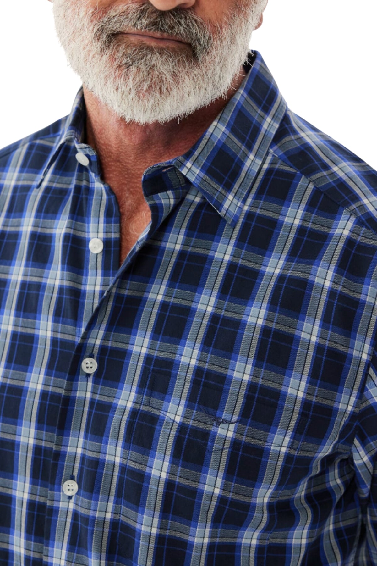 A close-up of a person with a white beard wearing the RM Williams Hervey Shirt, featuring a blue and white plaid pattern. Only the lower part of their face and upper torso are visible, showcasing the short-sleeve silhouette made of breathable cotton.